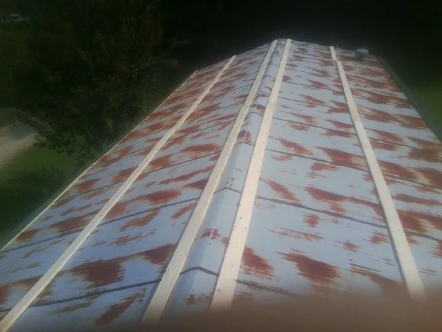 Rusted metal roof panels with new wood purlins before replacement — Storm Damage Roof Repair in New Tripoli by Roofing Brothers